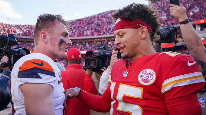 Denver Broncos quarterback Bo Nix (10) talks with Kansas City Chiefs quarterback Patrick Mahomes (15) after the game at GEHA Field at Arrowhead Stadium.