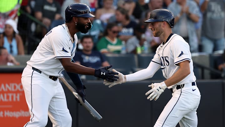 Tampa Bay Rays second baseman Brandon Lowe (right) celebrates with third base Junior Caminero after hitting a home run.