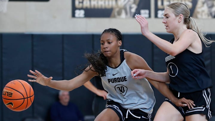 Purdue Boilermakers guard Tara Daye is defended by guard Taylor Feldman 