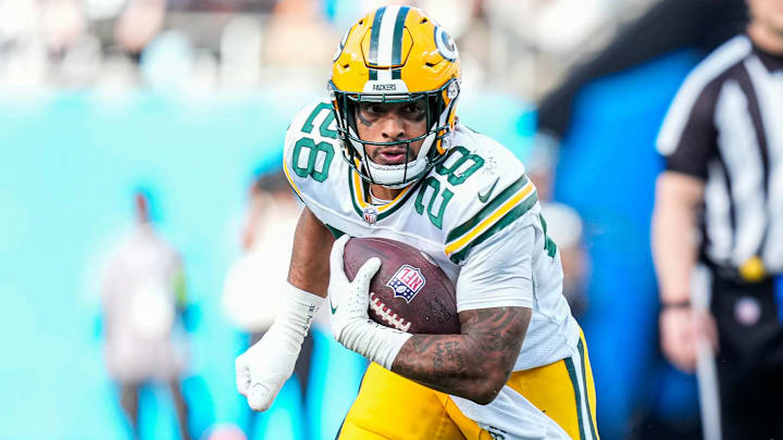 Dec 24, 2023; Charlotte, North Carolina, USA; Green Bay Packers running back AJ Dillon (28) against the Carolina Panthers during the second half at Bank of America Stadium.