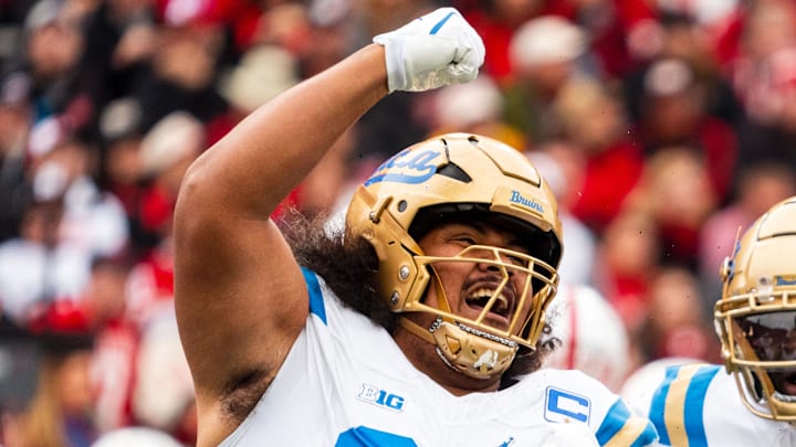 Nov 2, 2024; Lincoln, Nebraska, USA; UCLA Bruins defensive lineman Jay Toia (93) and linebacker Oluwafemi Oladejo (2) celebrate after a sack against the Nebraska Cornhuskers during the first quarter at Memorial Stadium. Mandatory Credit: Dylan Widger-Imagn Images