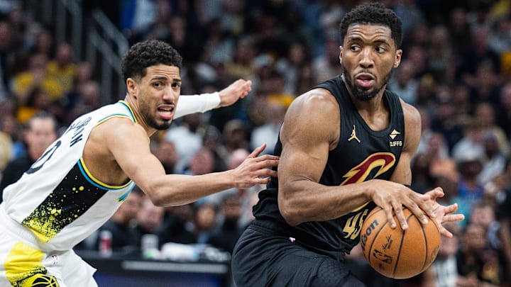 May 11, 2025; Indianapolis, Indiana, USA; Cleveland Cavaliers guard Donovan Mitchell (45) dribbles the ball while Indiana Pacers guard Tyrese Haliburton (0) defends during game four of the second round for the 2025 NBA Playoffs at Gainbridge Fieldhouse. Mandatory Credit: Trevor Ruszkowski-Imagn Images