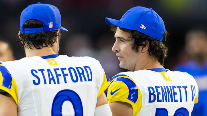 Dec 7, 2025; Glendale, Arizona, USA; Los Angeles Rams quarterback Stetson Bennett IV (13) with Matthew Stafford (9) against the Arizona Cardinals at State Farm Stadium. Mandatory Credit: Mark J. Rebilas-Imagn Images Dec 7, 2025; Glendale, Arizona, USA; Los Angeles Rams quarterback Stetson Bennett IV (13) with Matthew Stafford (9) against the Arizona Cardinals at State Farm Stadium. Mandatory Credit: Mark J. Rebilas-Imagn Images