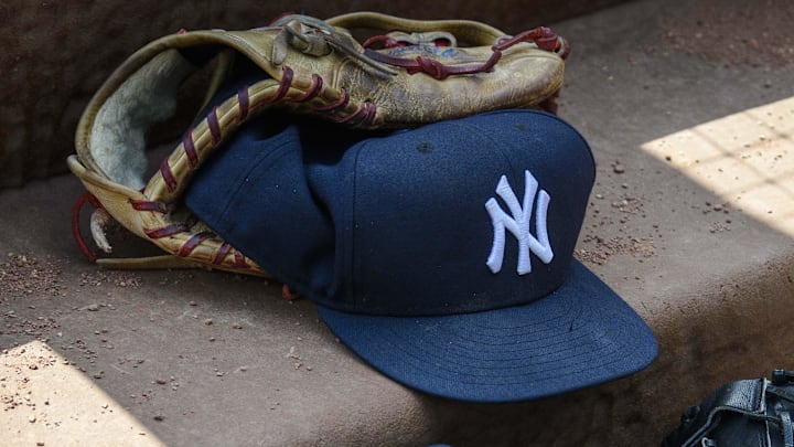 Sep 29, 2019; Arlington, TX, USA; A view of a New York Yankees cap and glove and logo during the game between the Rangers and the Yankees in the final home game at Globe Life Park in Arlington. Mandatory Credit: Jerome Miron-Imagn Images Sep 29, 2019; Arlington, TX, USA; A view of a New York Yankees cap and glove and logo during the game between the Rangers and the Yankees in the final home game at Globe Life Park in Arlington. Mandatory Credit: Jerome Miron-Imagn Images