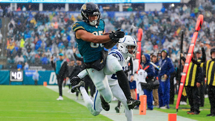 Jacksonville Jaguars tight end Brenton Strange (85) leaps for a touchdown as Indianapolis Colts cornerback Mekhi Blackmon (29) defends but is called back on a penalty during the fourth quarter of an NFL football game at EverBank Stadium, Sunday, Dec. 7, 2025, in Jacksonville, Fla. The Jaguars defeated the Colts 36-19. [Corey Perrine/Florida Times-Union]