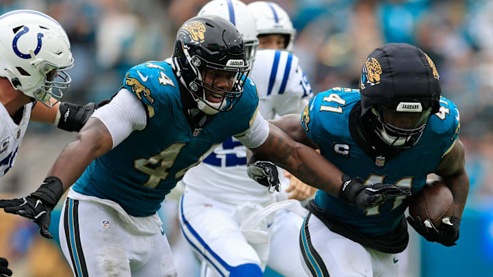 Jacksonville Jaguars defensive end Josh Hines-Allen (41) rushes for yards after picking up a fumble turnover forced by defensive end Travon Walker (44) during the second quarter of an NFL football matchup Sunday, Oct. 6, 2024 at EverBank Stadium in Jacksonville, Fla. The Jaguars edged the Colts on a field goal 37-34. [Corey Perrine/Florida Times-Union]