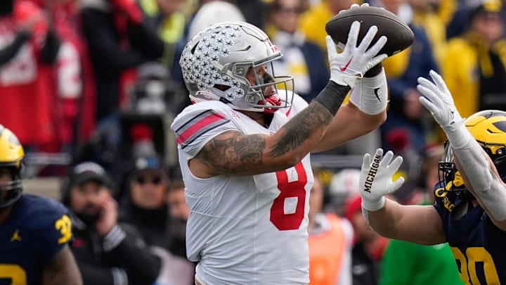 Nov 25, 2023; Ann Arbor, Michigan, USA; Ohio State Buckeyes tight end Cade Stover (8) catches a pass over Michigan Wolverines linebacker Jimmy Rolder (30) during the first half of the NCAA football game at Michigan Stadium. Nov 25, 2023; Ann Arbor, Michigan, USA; Ohio State Buckeyes tight end Cade Stover (8) catches a pass over Michigan Wolverines linebacker Jimmy Rolder (30) during the first half of the NCAA football game at Michigan Stadium.
