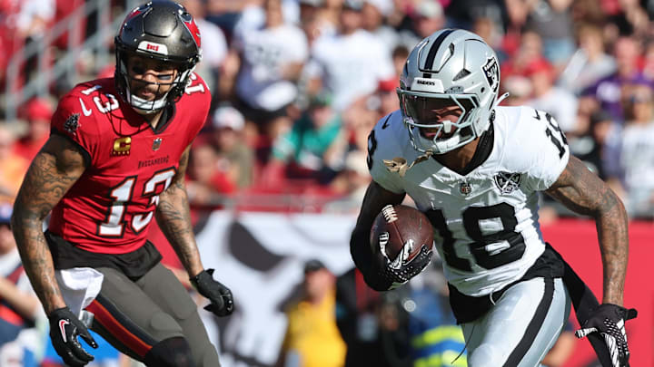 Dec 8, 2024; Tampa, Florida, USA; Las Vegas Raiders cornerback Jack Jones (18) runs with the ball after he intercepted in the end zone against the Tampa Bay Buccaneers during the second quarter at Raymond James Stadium. Mandatory Credit: Kim Klement Neitzel-Imagn Images