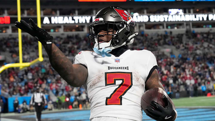 Dec 1, 2024; Charlotte, North Carolina, USA; Tampa Bay Buccaneers running back Bucky Irving (7) blows a kiss to the crowd after scoring a touchdown in the fourth quarter at Bank of America Stadium. Mandatory Credit: Bob Donnan-Imagn Images