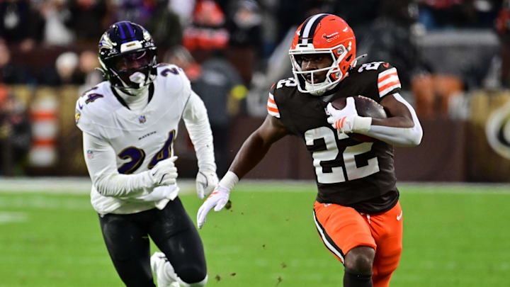 Nov 16, 2025; Cleveland, Ohio, USA; Cleveland Browns running back Dylan Sampson (22) runs for a gain past Baltimore Ravens safety Malaki Starks (24) during the first quarter at Huntington Bank Field. Mandatory Credit: Ken Blaze-Imagn Images