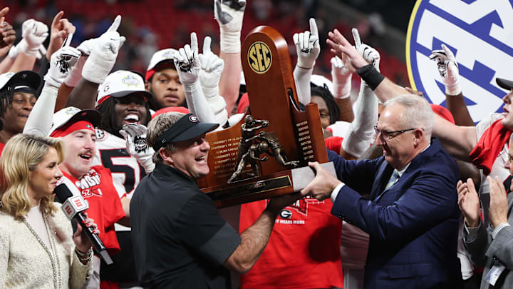 Dec 6, 2025; Atlanta, GA, USA; Georgia Bulldogs head coach Kirby Smart lifts the SEC Championship trophy after the game against the Alabama Crimson Tide during the 2025 SEC Championship game at Mercedes-Benz Stadium. Mandatory Credit: Brett Davis-Imagn Images
