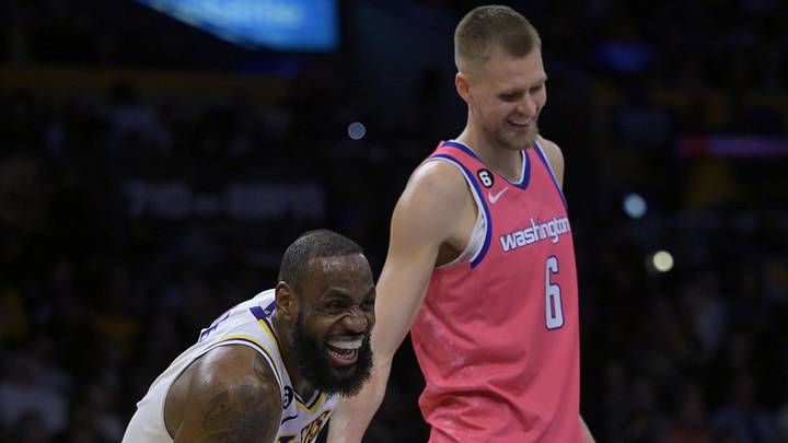 Dec 18, 2022; Los Angeles, California, USA; Los Angeles Lakers forward LeBron James (6) and Washington Wizards center Kristaps Porzingis (6) share a laugh in the second half at Crypto.com Arena. Mandatory Credit: Jayne Kamin-Oncea-Imagn Images
