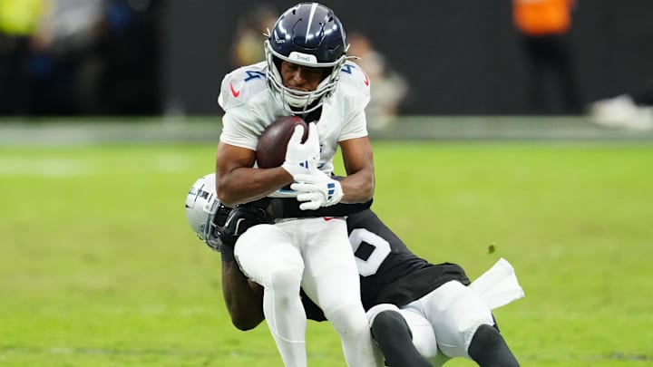 Oct 12, 2025; Paradise, Nevada, USA; Las Vegas Raiders cornerback Kyu Blu Kelly (36) attempts a tackle on Tennessee Titans wide receiver Tyler Lockett (4) during the second half at Allegiant Stadium. Mandatory Credit: Stephen R. Sylvanie-Imagn Images Oct 12, 2025; Paradise, Nevada, USA; Las Vegas Raiders cornerback Kyu Blu Kelly (36) attempts a tackle on Tennessee Titans wide receiver Tyler Lockett (4) during the second half at Allegiant Stadium. Mandatory Credit: Stephen R. Sylvanie-Imagn Images