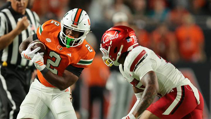 Oct 17, 2025; Miami Gardens, Florida, USA; Miami Hurricanes running back Jordan Lyle (2) runs out of bounds as Louisville Cardinals defensive back Jojo Evans Jr. (27) defends during the fourth quarter at Hard Rock Stadium. Mandatory Credit: Sam Navarro-Imagn Images Oct 17, 2025; Miami Gardens, Florida, USA; Miami Hurricanes running back Jordan Lyle (2) runs out of bounds as Louisville Cardinals defensive back Jojo Evans Jr. (27) defends during the fourth quarter at Hard Rock Stadium. Mandatory Credit: Sam Navarro-Imagn Images