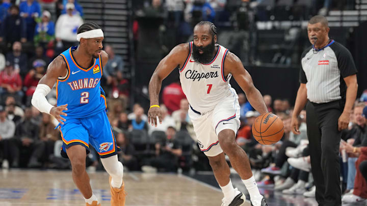 Nov 4, 2025; Inglewood, California, USA; LA Clippers guard James Harden (1) dribbles the ball against Oklahoma City Thunder guard Shai Gilgeous-Alexander (2) in the first half at Intuit Dome. Mandatory Credit: Kirby Lee-Imagn Images