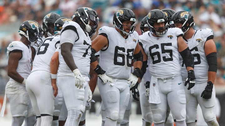 Sep 15, 2024; Jacksonville, Florida, USA;  Jacksonville Jaguars offensive line Anton Harrison (77), offensive line Brandon Scherff (68), and offensive line Mitch Morse (65) wait to line up for the drive against the Cleveland Browns during the third quarter at EverBank Stadium. Mandatory Credit: Morgan Tencza-Imagn Images