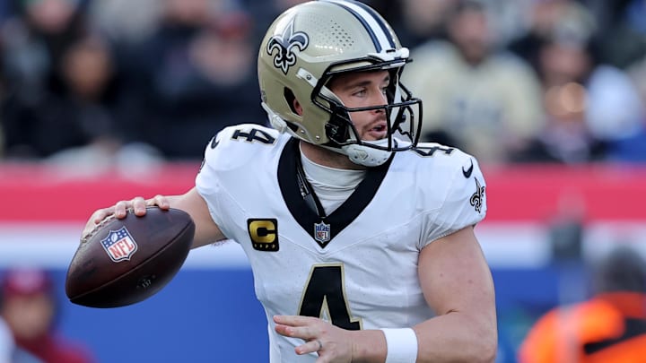 Dec 8, 2024; East Rutherford, New Jersey, USA; New Orleans Saints quarterback Derek Carr (4) drops back to pass against the New York Giants during the first quarter at MetLife Stadium. Mandatory Credit: Brad Penner-Imagn Images