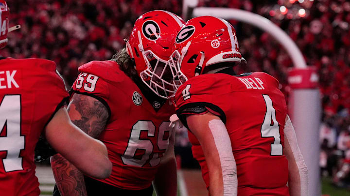 Georgia tight end Oscar Delp (4) celebrates with Georgia offensive lineman Tate Ratledge (69) after scoring a touchdown