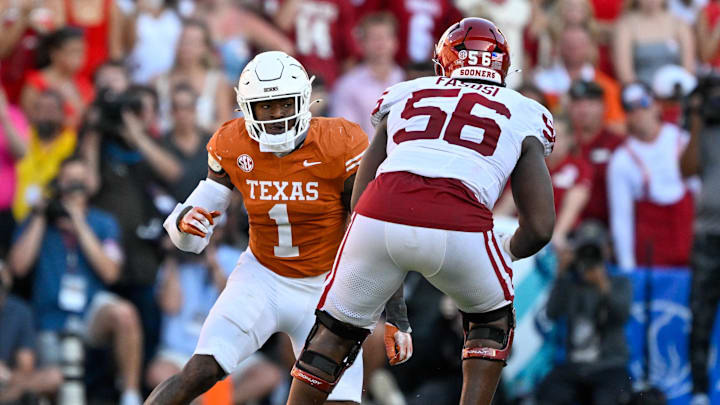 Oklahoma Sooners offensive lineman Michael Fasusi blocks Texas Longhorns defensive end Colin Simmons during the game between the Texas Longhorns and the Oklahoma Sooners at the Cotton Bowl.