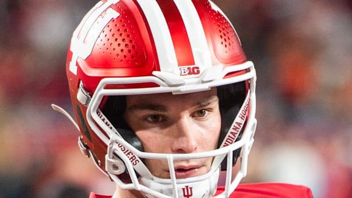 Indiana's Fernando Mendoza (15) gets loose before the College Football Playoff National Championship college football game at Hard Rock Stadium in Miami Gardens on Monday, Jan. 19, 2026.