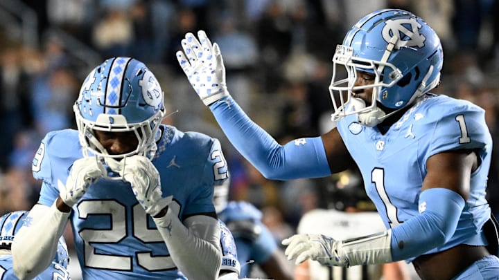 Nov 16, 2024; Chapel Hill, North Carolina, USA; North Carolina Tar Heels defensive back Marcus Allen (29) reacts with defensive back Antavious Lane (1) after intercepting the ball in the third quarter at Kenan Memorial Stadium. Mandatory Credit: Bob Donnan-Imagn Images