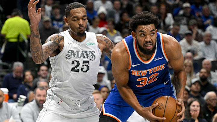 Nov 27, 2024; Dallas, Texas, USA; New York Knicks center Karl-Anthony Towns (32) grabs a rebound in front of Dallas Mavericks forward P.J. Washington (25) during the first quarter at the American Airlines Center. Mandatory Credit: Jerome Miron-Imagn Images