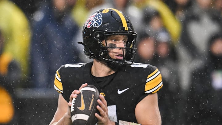 Nov 8, 2025; Iowa City, Iowa, USA; Iowa Hawkeyes quarterback Mark Gronowski (11) prepares to throw a pass against the Oregon Ducks during the first quarter at Kinnick Stadium. Mandatory Credit: Jeffrey Becker-Imagn Images
