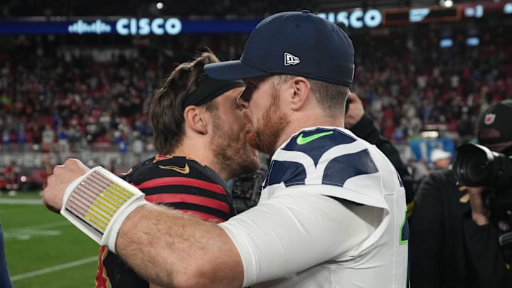 Jan 3, 2026; Santa Clara, California, USA; Seattle Seahawks quarterback Sam Darnold (14) reacts with San Francisco 49ers fullback Kyle Juszczyk (44) after the game at Levi's Stadium. Mandatory Credit: Neville E. Guard-Imagn Images