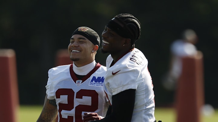 Washington Commanders running back Brian Robinson Jr. (8) jokes with Commanders running back Kaz Allen (22).