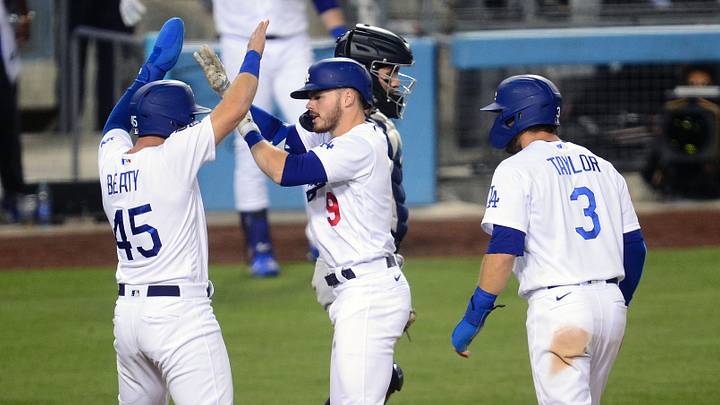 Los Angeles Dodgers second baseman Gavin Lux (9) is greeted by center fielder Chris Taylor (3) and infielder Matt Beaty (45) after hitting a two run home run against the Seattle Mariners during the eighth inning at Dodger Stadium on May 11, 2021. Los Angeles Dodgers second baseman Gavin Lux (9) is greeted by center fielder Chris Taylor (3) and infielder Matt Beaty (45) after hitting a two run home run against the Seattle Mariners during the eighth inning at Dodger Stadium on May 11, 2021.