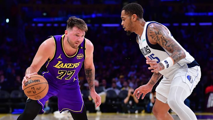 Feb 25, 2025; Los Angeles, California, USA; Los Angeles Lakers guard Luka Doncic (77) dribbles the ball against Dallas Mavericks forward P.J. Washington (25) during the second half at Crypto.com Arena. Mandatory Credit: Gary A. Vasquez-Imagn Images