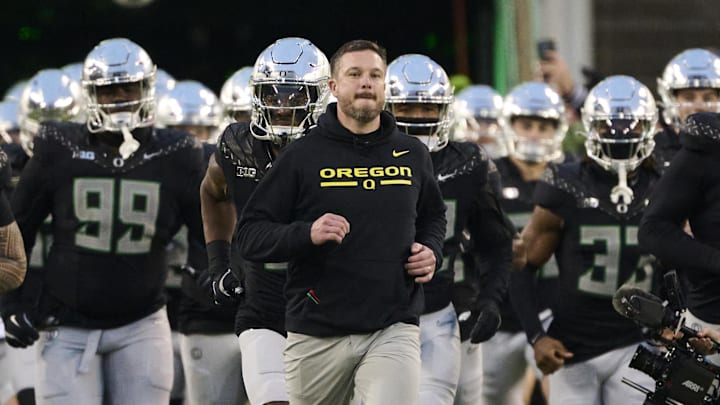 Nov 30, 2024; Eugene, Oregon, USA; Oregon Ducks head coach Dan Lanning runs out with the team before a game against the Washington Huskies at Autzen Stadium. Mandatory Credit: Troy Wayrynen-Imagn Images