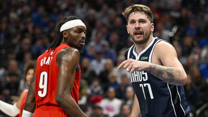 Jan 3, 2024; Dallas, Texas, USA; Dallas Mavericks guard Luka Doncic (77) argues a call as Portland Trail Blazers forward Jerami Grant (9) looks on during the second half at the American Airlines Center. Mandatory Credit: Jerome Miron-USA TODAY Sports