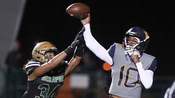 Warren quarterback Madden Iamaleava is under pressure by St. Bonaventure's Jacob Moraga as he fires a pass during the first quarter of the Seraphs' 24-21 win in the CIF-SS Division 3 championship game on Saturday, Nov. 25, 2023, at Ventura High's Larrabee Stadium. Warren quarterback Madden Iamaleava is under pressure by St. Bonaventure's Jacob Moraga as he fires a pass during the first quarter of the Seraphs' 24-21 win in the CIF-SS Division 3 championship game on Saturday, Nov. 25, 2023, at Ventura High's Larrabee Stadium.