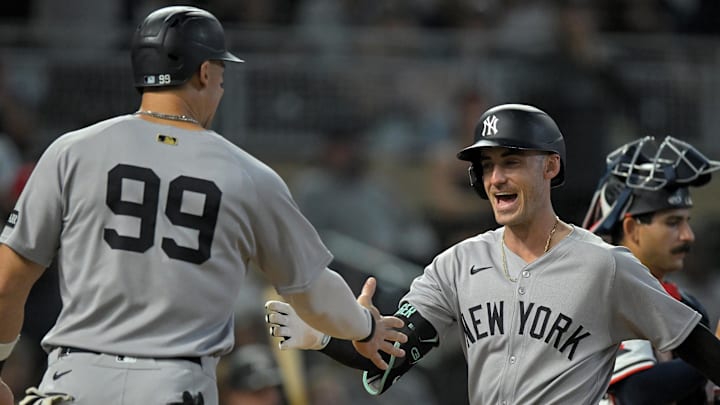 Sep 17, 2025; Minneapolis, Minnesota, USA;  New York Yankees designated hitter Aaron Judge (99) congratulates outfielder Cody Bellinger (35) on his two-run home run against the Minnesota Twins during the ninth inning at Target Field. Mandatory Credit: Nick Wosika-Imagn Images