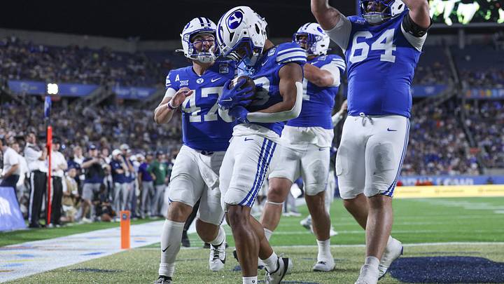 Dec 27, 2025; Orlando, FL, USA; BYU Cougars running back Jovesa Damuni (28) reacts after scoring a touchdown against the Georgia Tech Yellow Jackets in the fourth quarter during the Pop-Tarts Bowl at Camping World Stadium. Mandatory Credit: Nathan Ray Seebeck-Imagn Images