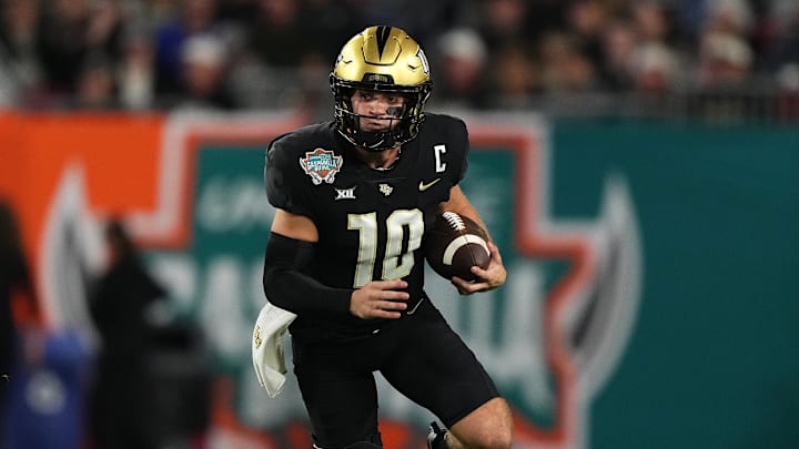 Dec 22, 2023; Tampa, FL, USA; UCF Knights quarterback John Rhys Plumlee (10) scrambles with the ball during the first half of the Gasparilla Bowl against the Georgia Tech Yellow Jackets at Raymond James Stadium. Mandatory Credit: Jasen Vinlove-Imagn Images