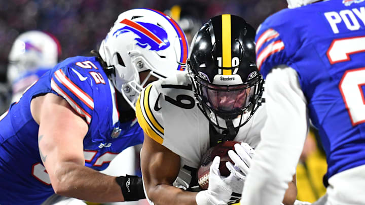 Jan 15, 2024; Orchard Park, New York, USA; Pittsburgh Steelers wide receiver Calvin Austin III (19) runs the ball pressured by Buffalo Bills linebacker A.J. Klein (52) in the second half in a 2024 AFC wild card game at Highmark Stadium. Mandatory Credit: Mark Konezny-USA TODAY Sports