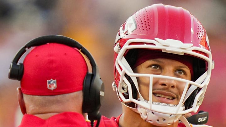 Sep 28, 2025; Kansas City, Missouri, USA; Kansas City Chiefs quarterback Patrick Mahomes (15) talks with head coach Andy Reid during the second half against the Baltimore Ravens at GEHA Field at Arrowhead Stadium. Mandatory Credit: Jay Biggerstaff-Imagn Images