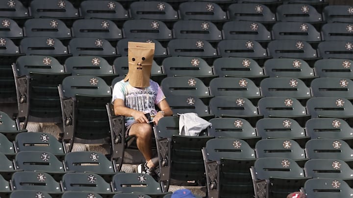 Aug 28, 2024; Chicago, IL, USA; A Chicago White Sox fan watches the game against the Texas Rangers at Rate Field. 
