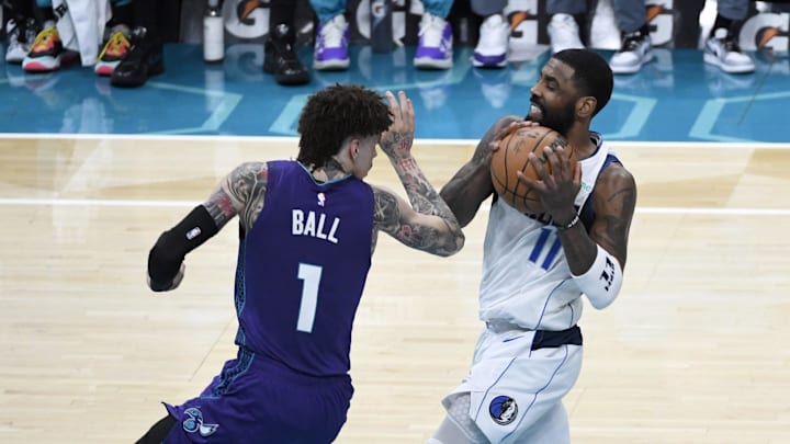 Jan 20, 2025; Charlotte, North Carolina, USA; Dallas Mavericks guard Kyrie Irving (11) drives past Charlotte Hornets guard LaMelo Ball (1) during the second half at the Spectrum Center. Mandatory Credit: Sam Sharpe-Imagn Images Jan 20, 2025; Charlotte, North Carolina, USA; Dallas Mavericks guard Kyrie Irving (11) drives past Charlotte Hornets guard LaMelo Ball (1) during the second half at the Spectrum Center. Mandatory Credit: Sam Sharpe-Imagn Images