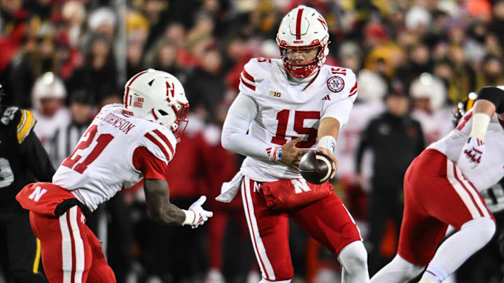 Nebraska quarterback Dylan Raiola hands off to running back Emmett Johnson against Iowa on Nov. 29. Nebraska quarterback Dylan Raiola hands off to running back Emmett Johnson against Iowa on Nov. 29.