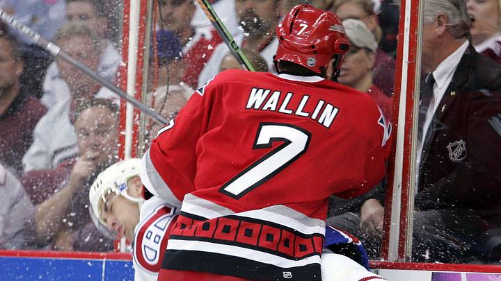 Apr 24, 2006; Raleigh, NC, USA; Montreal Canadiens center (38) Jan Bulis is checked by Carolina Hurricanes defensemen (7) Niclas Wallin during the 1st period at the RBC Center.  Mandatory Credit: James Guillory-USA TODAY Sports Copyright (c) 2006 James Guillory