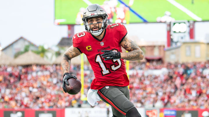 Dec 24, 2023; Tampa, Florida, USA;Tampa Bay Buccaneers wide receiver Mike Evans (13) catches the touchdown against the Jacksonville Jaguars in the second quarter  at Raymond James Stadium. Mandatory Credit: Jeremy Reper-Imagn Images