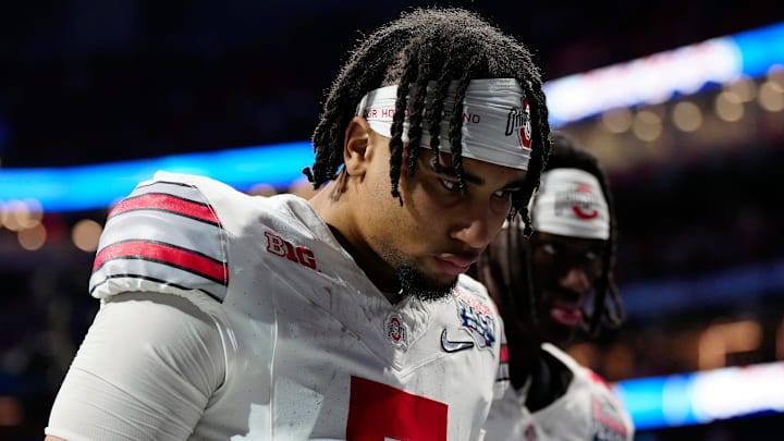 Dec 31, 2022; Atlanta, Georgia, USA; Ohio State Buckeyes quarterback C.J. Stroud (7) walks off the field after losing 42-41 to Georgia Bulldogs during the Peach Bowl in the College Football Playoff semifinal at Mercedes-Benz Stadium.
