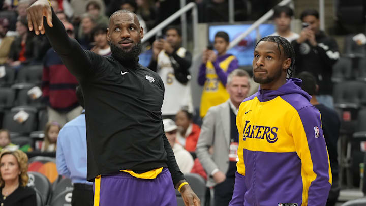 Nov 1, 2024; Toronto, Ontario, CAN; Los Angeles Lakers forward LeBron James (left) and guard Bronny James (right) during warm up before a game agaonst the Toronto Raptors at Scotiabank Arena. Mandatory Credit: John E. Sokolowski-Imagn Images