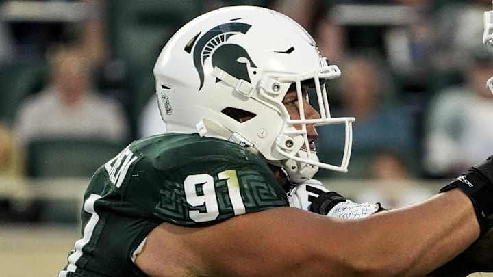 Aug 29, 2025; East Lansing, Michigan, USA; Michigan State Spartans defensive lineman Alex VanSumeren (91) engages with Western Michigan Broncos offensive lineman Raheem Anderson II (62) during the 2nd quarter at Spartan Stadium. Mandatory Credit: Brendan Mullin-Imagn Images