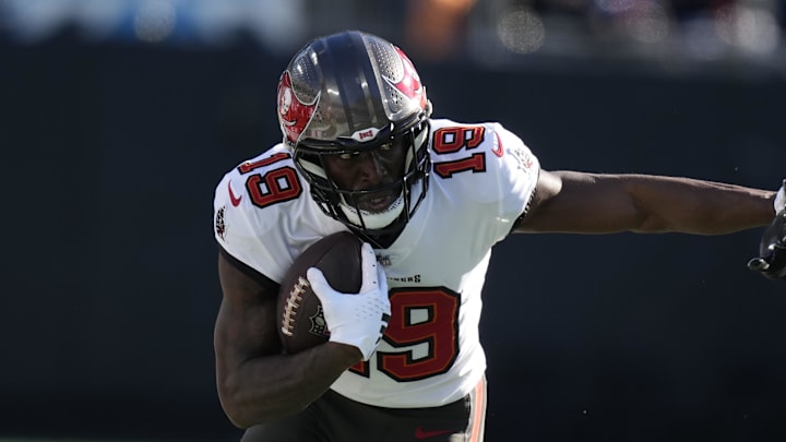 Jan 7, 2024; Charlotte, North Carolina, USA; Tampa Bay Buccaneers wide receiver Rakim Jarrett (18) rushes the ball against Carolina Panthers linebacker Deion Jones (40) during the second quarter at Bank of America Stadium. Mandatory Credit: Jim Dedmon-Imagn Images