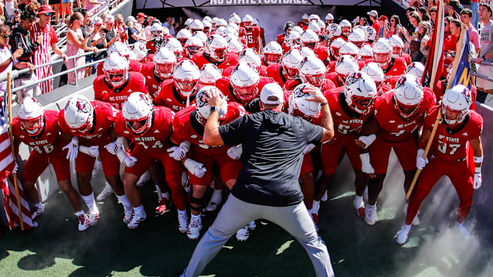 Oct 4, 2025; Raleigh, North Carolina, USA;  NC State Wolfpack head coach Dave Doeren with his team prepare to run out prior to the first half of the game against Campbell Fighting Camels at Carter-Finley Stadium. Mandatory Credit: Jaylynn Nash-Imagn Images