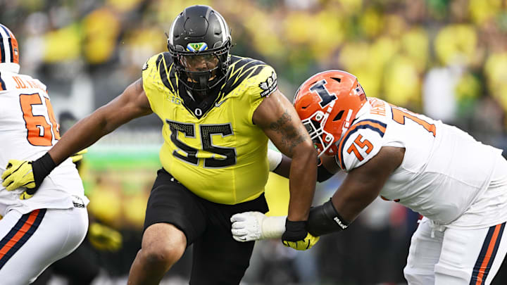 Oct 26, 2024; Eugene, Oregon, USA; Oregon Ducks defensive lineman Derrick Harmon (55) breaks past Illinois Fighting Illini offensive lineman Brandon Henderson (75) during the second half at Autzen Stadium.